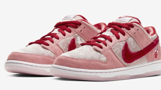 View of pink and red Nike Dunk shoes.